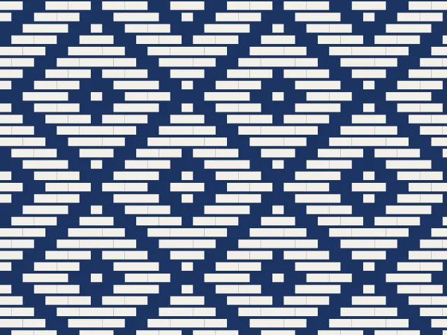 White counted rows forming nested diamonds on indigo cloth